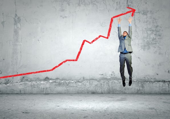 Image of young businessman jumping above graph