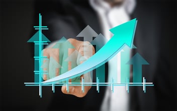 a businessman is using a touchscreen that shows an upward trending graph