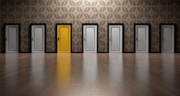 several doors along one wall. They all look the same except for one, which is yellow.