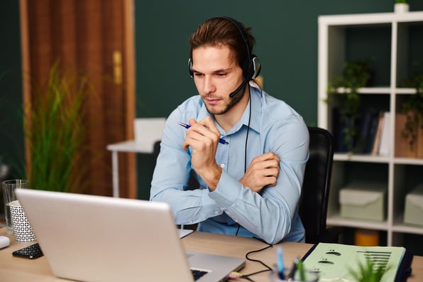 man working from home on a headset